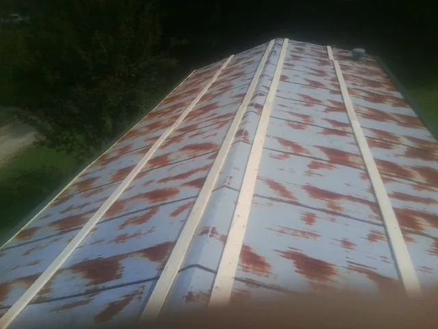 Rusted metal roof panels with new wood purlins before replacement — Storm Damage Roof Repair in North Stonington by Roofing Brothers