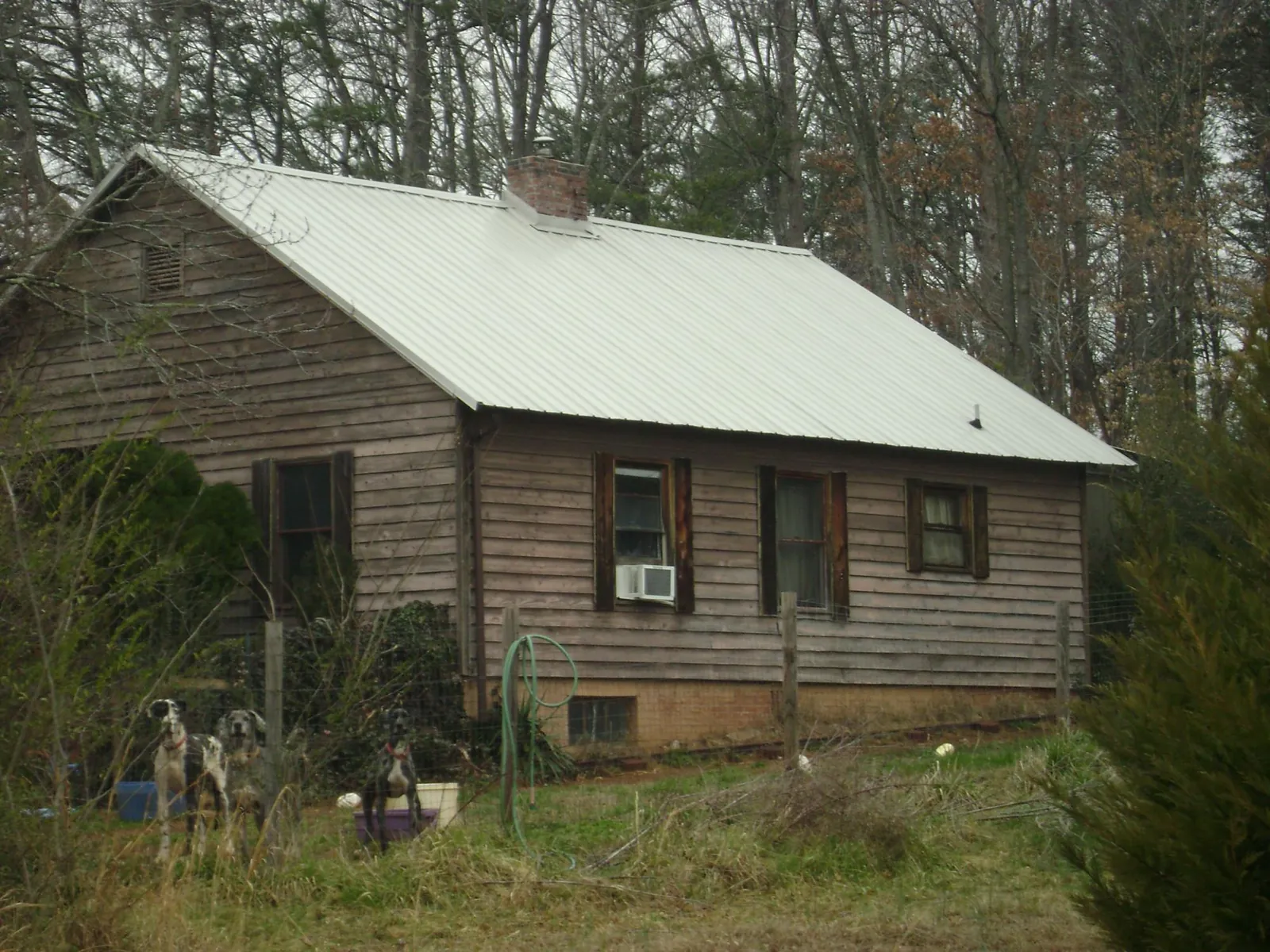 White metal roof on an old wood sided farmhouse, from a Metal Roof Installation job in North Stonington